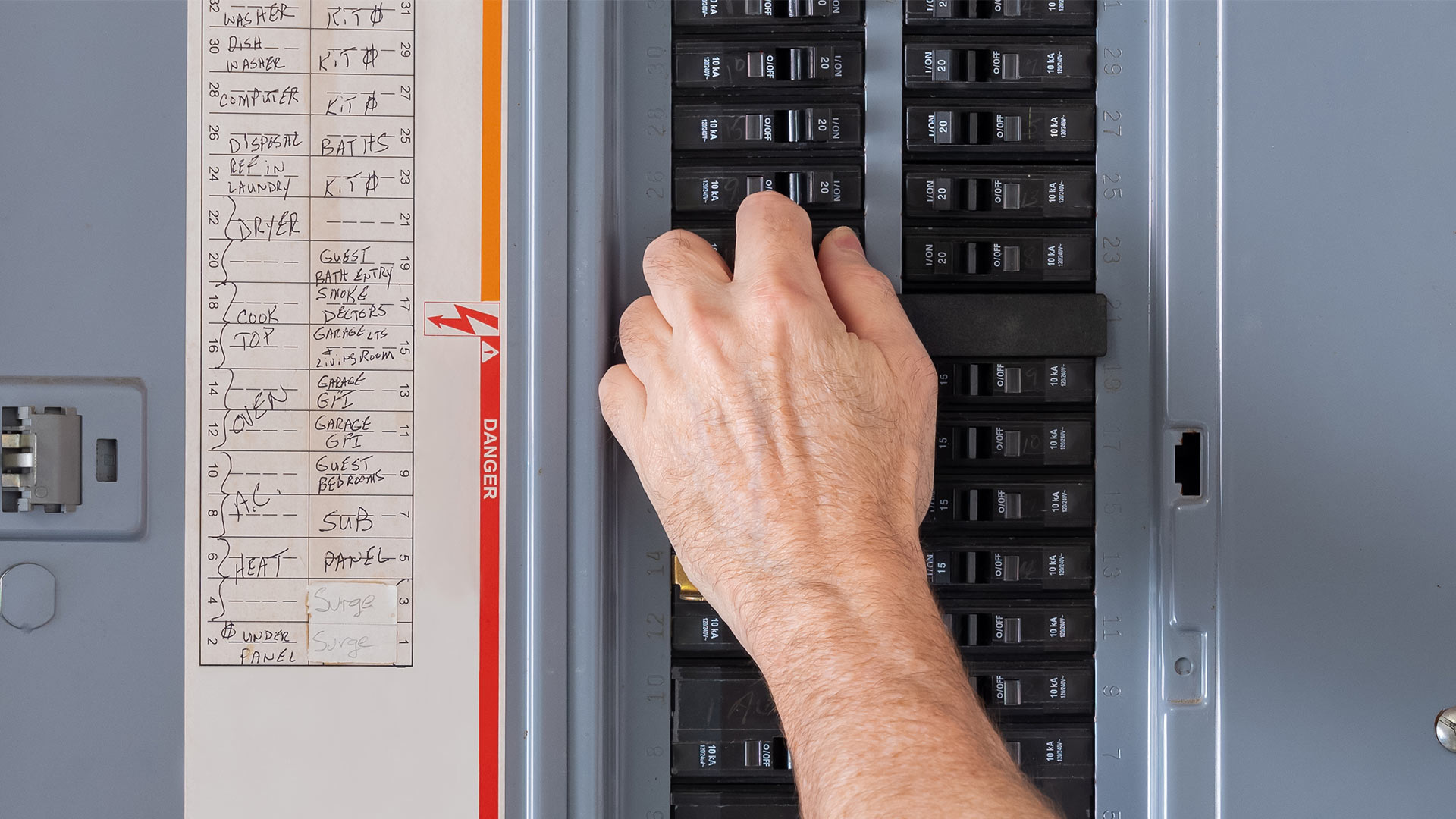 electrician hand close up checking electrical panel houston tx
